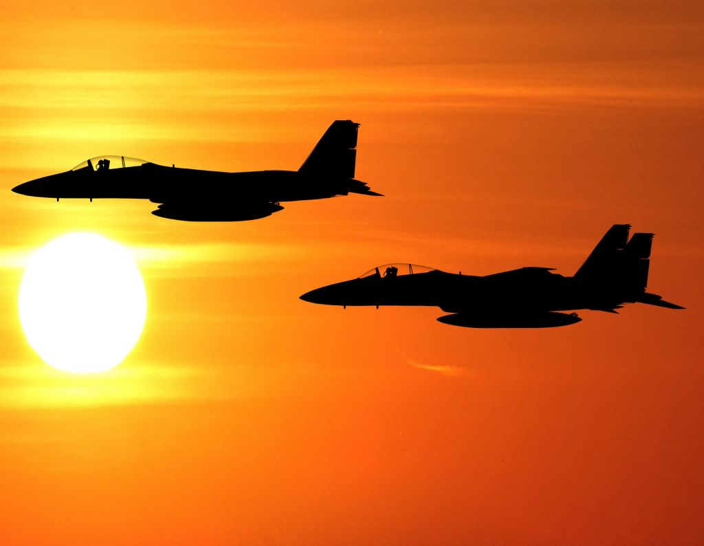 Fighter jets in tandem at sunset
